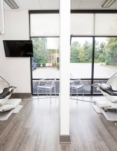 Two dental chairs are shown in a high-tech, clean, and modern office.